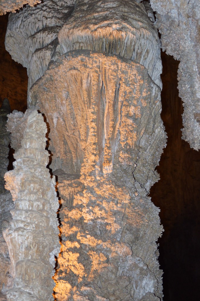 Large stalagmite backlit with golden light