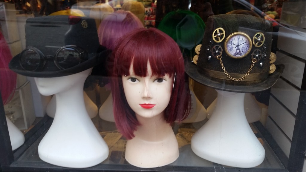 Wigs on wigstands in a window